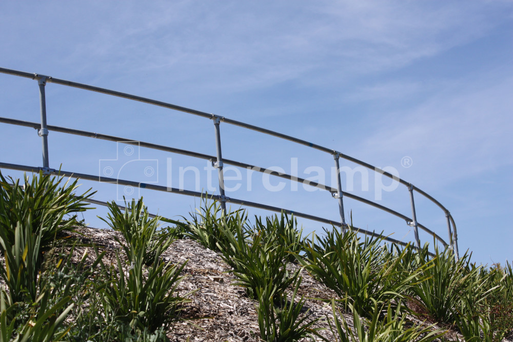 Curved balustrade installed on top of embankment for bike path